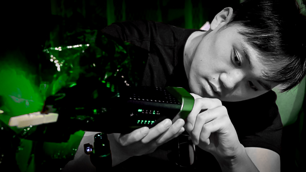 Aaroon Yang operating a cinema camera on set